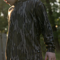 Combat Waterfowl Youth Hooded Performance Shirt Mossy Oak Bottomland view 1