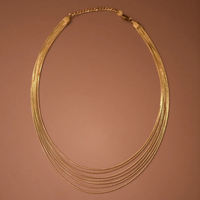 Layered gold necklace shown on model