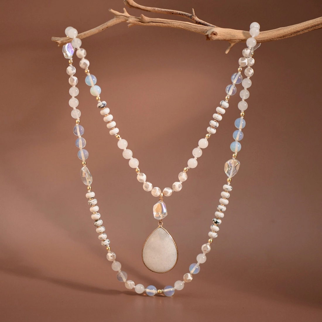 Stone pendant necklace shown on model