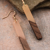 Close-up of nude resin and wood grain on elongated bar earrings