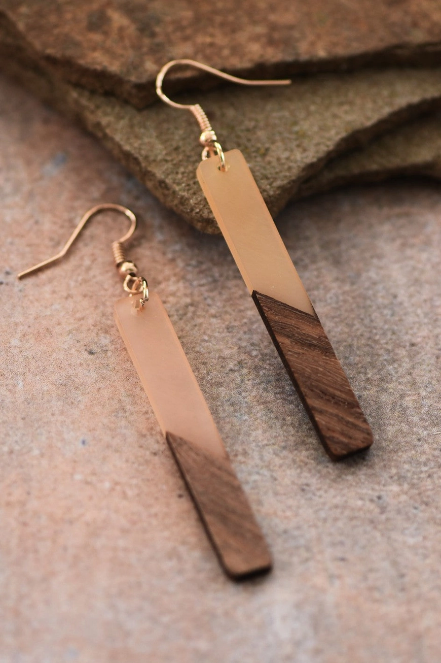 Close-up of nude resin and wood grain on elongated bar earrings