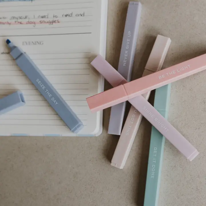 Neutral pastel highlighters in use with a planner