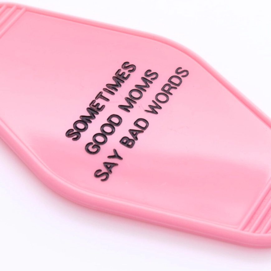 Close view of Good Moms motel keychain hot stamped lettering
