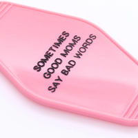 Close view of Good Moms motel keychain hot stamped lettering