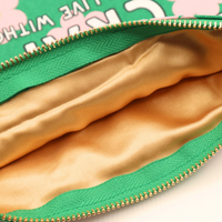 Gold satin interior of green floral canvas pouch