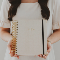 Woman holding neutral Sweet Water Decor recipe book