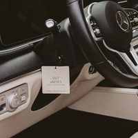 Salt and Sea air freshener hanging by a dashboard