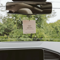 Salt and Sea air freshener hanging from a rearview mirror