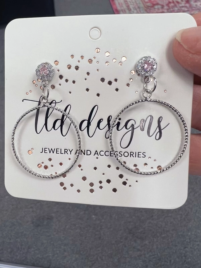 Close view of Pink Babies silver hoop earrings